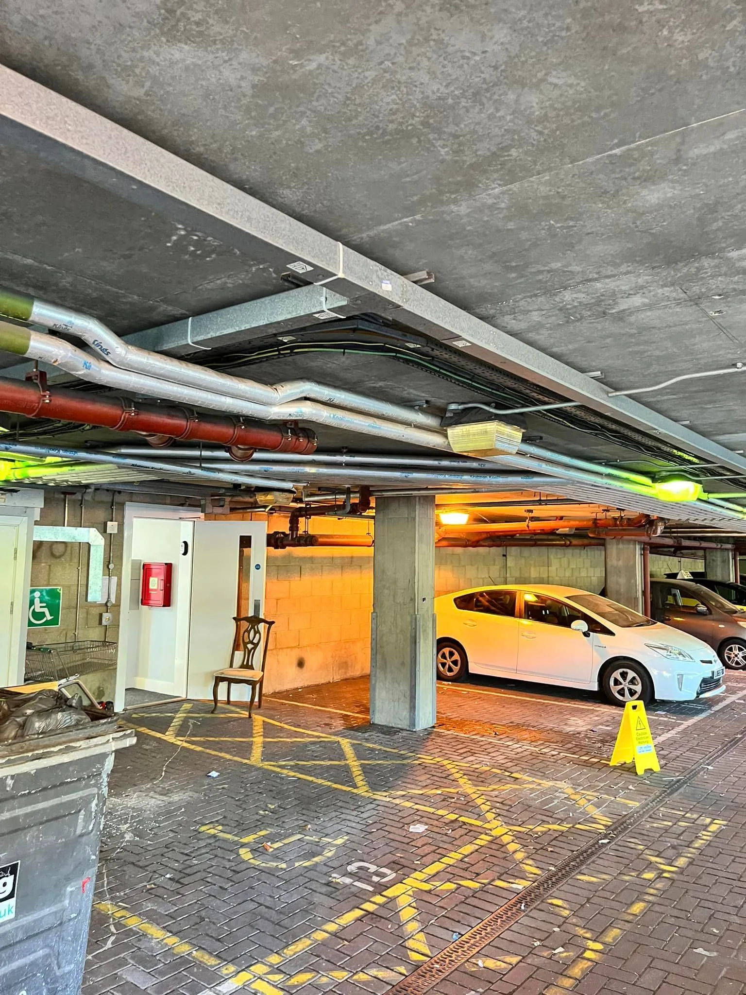 a parking garage with a few cars parked in it