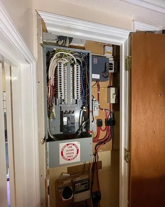 an electrical panel in a house with a door open