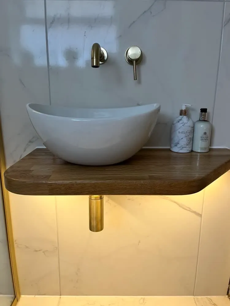a white bowl sink sitting on top of a wooden counter